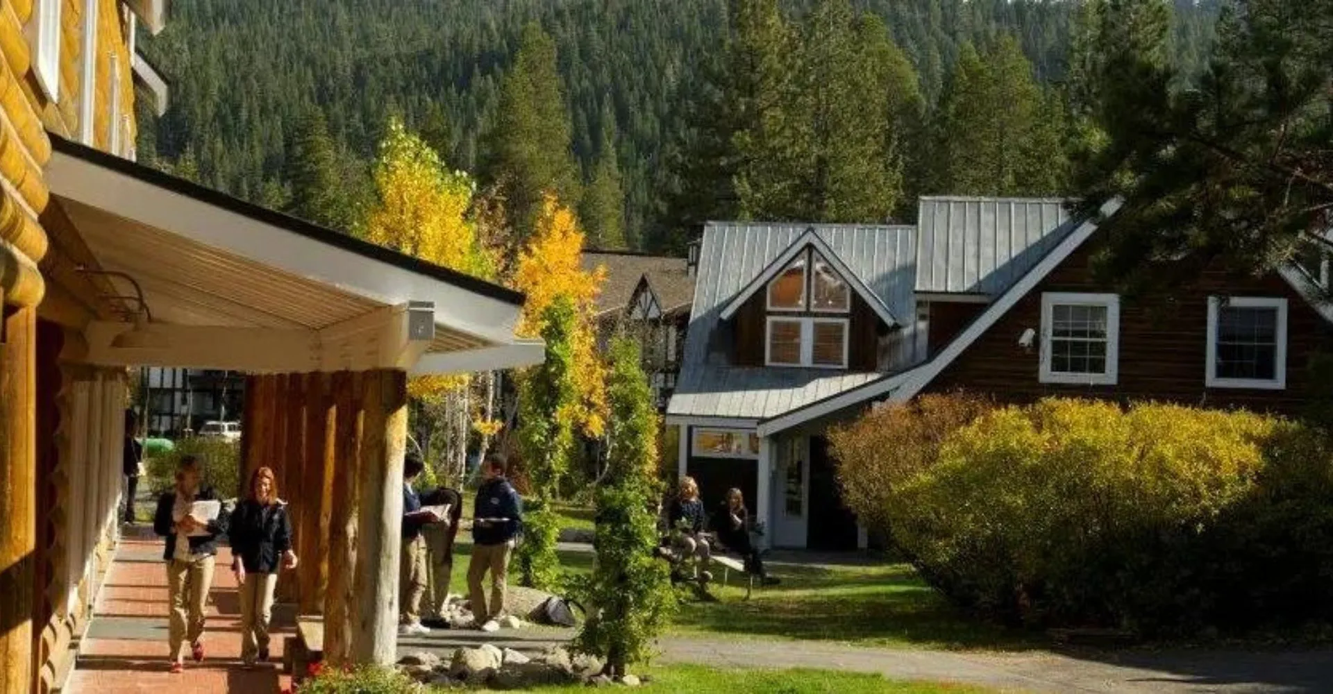 Una strada con case colorate in legno e persone a piedi nel campus della Lake Tahoe Preparatory School.
