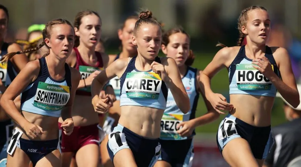 Un gruppo di studentesse della Menai High School corre durante una gara sulla pista da atletica.