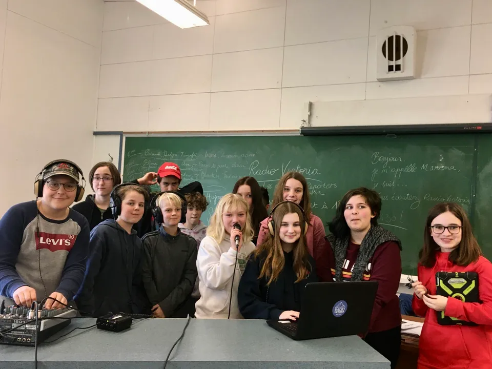 Un gruppo di studenti sta davanti a una lavagna nell'aula della École Côte du Soleil.