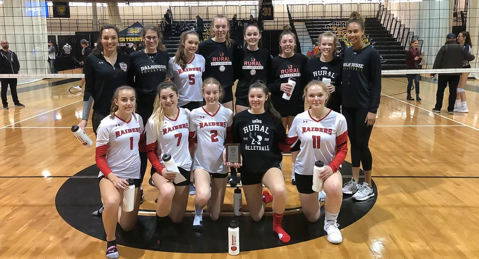 Un gruppo di giovani giocatrici di basket posa sul campo da gioco della Charlottetown Rural High School.