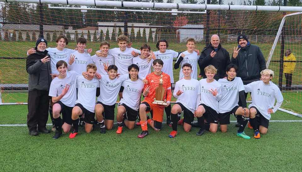Un gruppo di giovani calciatrici della Carihi Secondary School posa insieme sul campo da gioco.