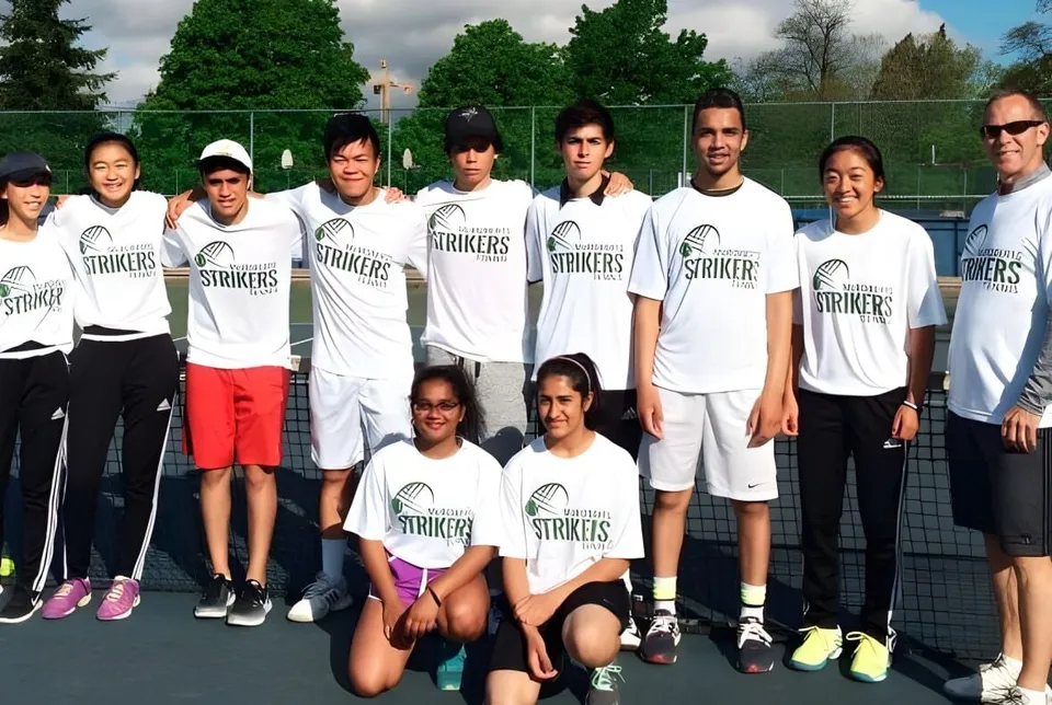 La squadra di tennis della Hugh McRoberts Secondary School posa insieme sul campo da tennis.