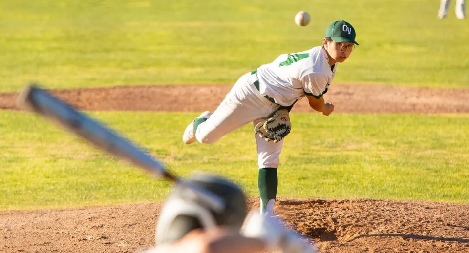 Un pitcher di baseball della Ojai Valley School si trova sul monte di lancio e si prepara a effettuare un lancio.