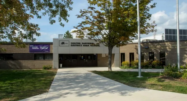 L'edificio moderno a due piani con un viale verso l'ingresso nel campus della Centre Dufferin District High School è circondato da alberi.
