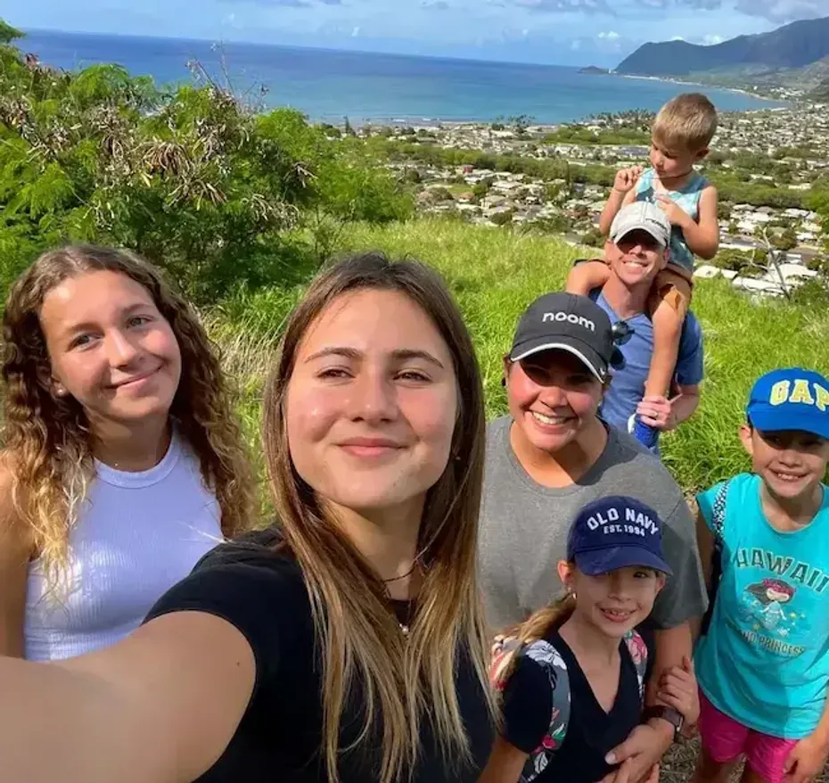Studentessa in gita con la famiglia ospitante su una collina affacciata sulla costa