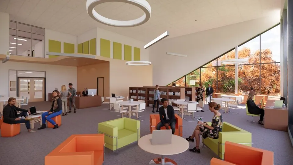 Spazio ufficio moderno con mobili colorati e grandi finestre nel campus della École secondaire publique Pierre de Blois.