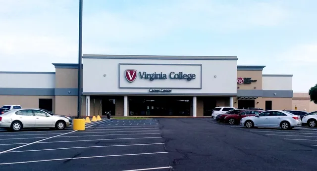 L'edificio esterno del Virginia College con una grande insegna e un parcheggio in primo piano è visibile sotto un cielo limpido.