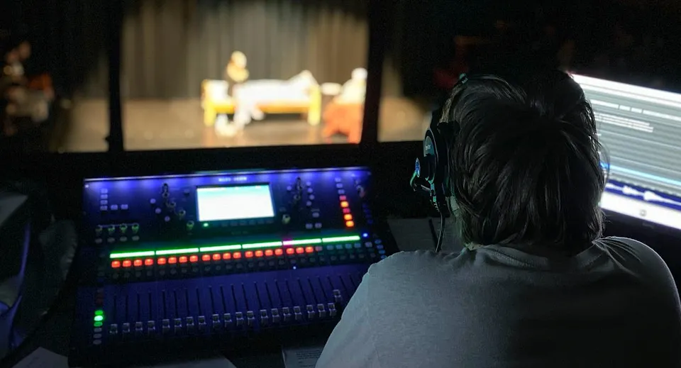 Una persona siede davanti a un computer con un complesso software di audio mixing sullo schermo presso la Imagine High Integrated Arts and Technology Secondary School.