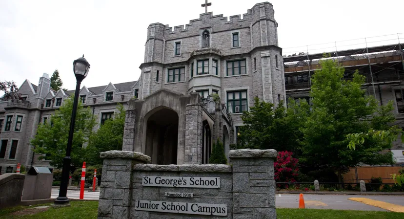 L'edificio principale in pietra del Junior School Campus della St. George’s School è circondato da alberi verdi.