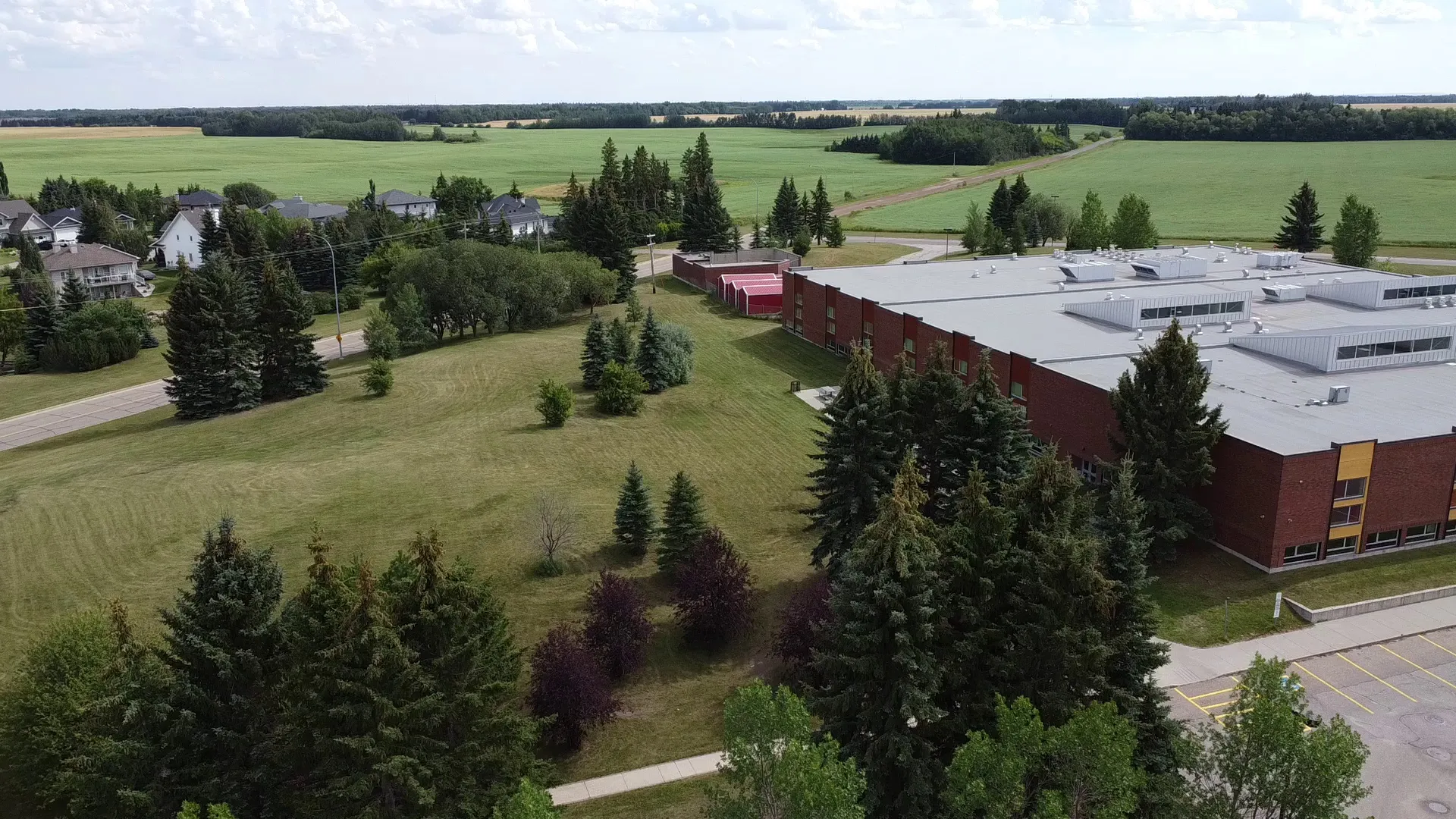 Vista aerea dell'edificio della Memorial Composite High School circondato da aree verdi e alberi a Stony Plain.