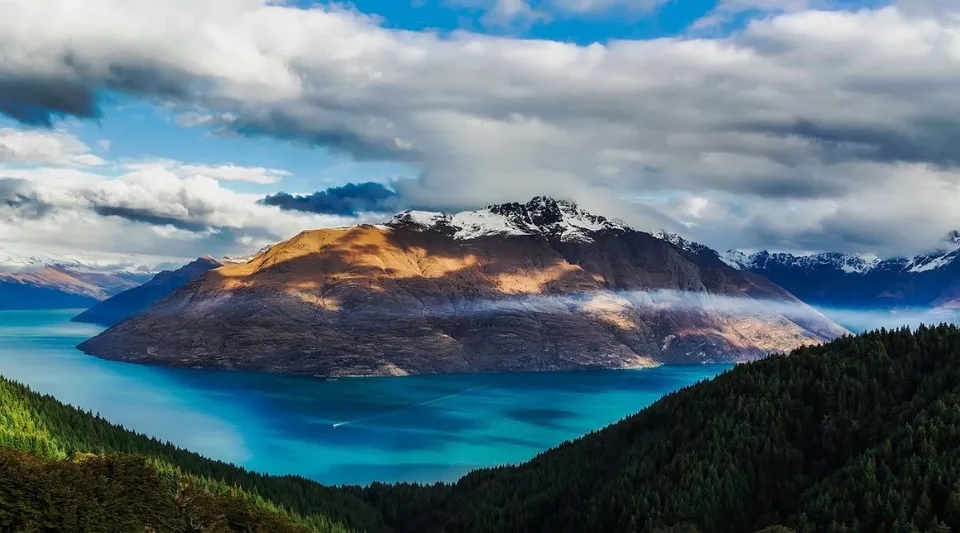 Una maestosa montagna si erge sopra un lago turchese, circondata da verdi foreste nel campus della Kalamunda Senior High School.