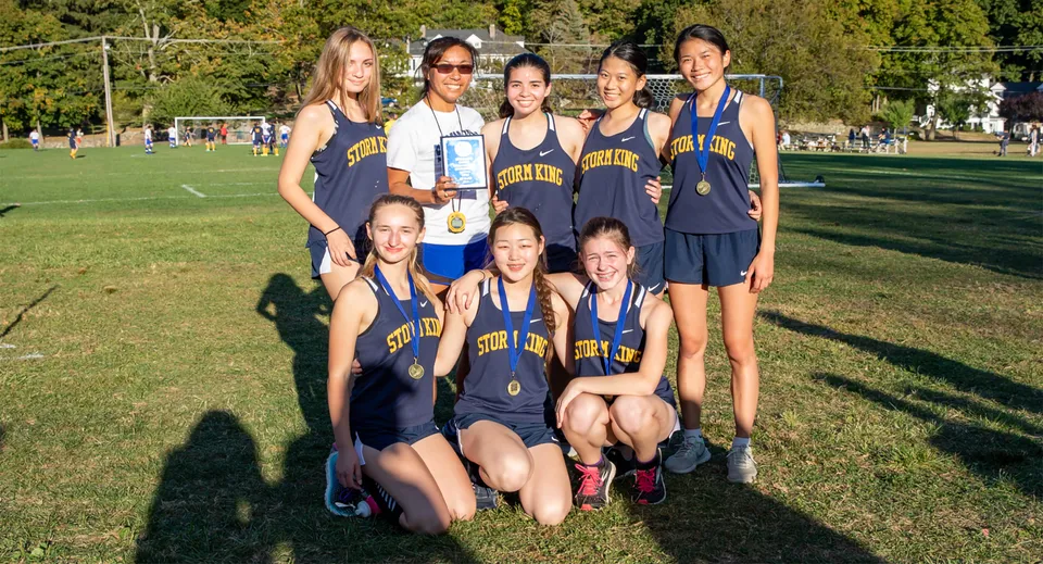 Un gruppo di giovani atlete posa insieme su un prato nel campus della Storm King School.