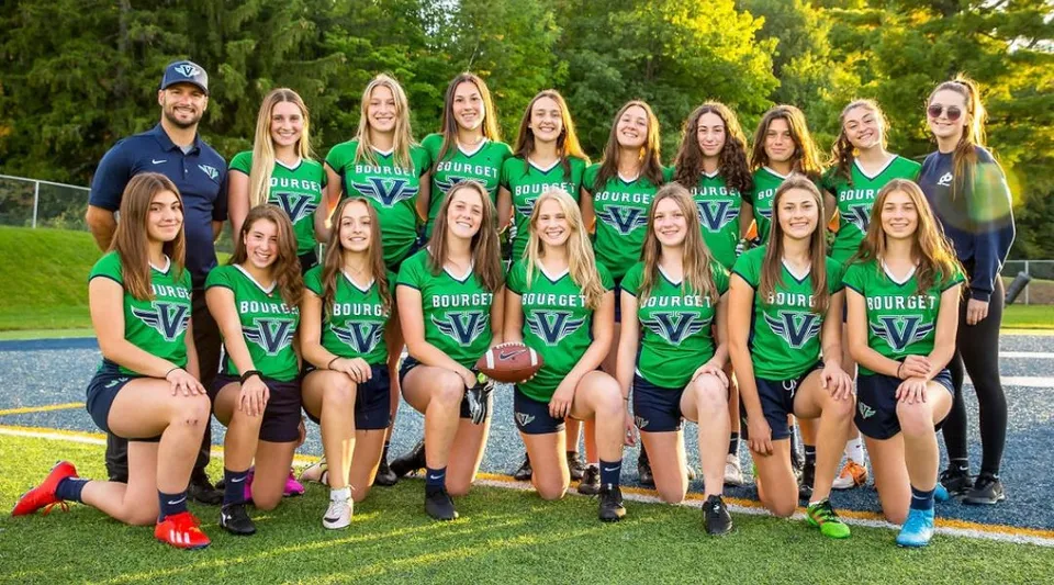 Un gruppo di giovani atlete in divisa verde e blu sul campo sportivo del College Bourget.