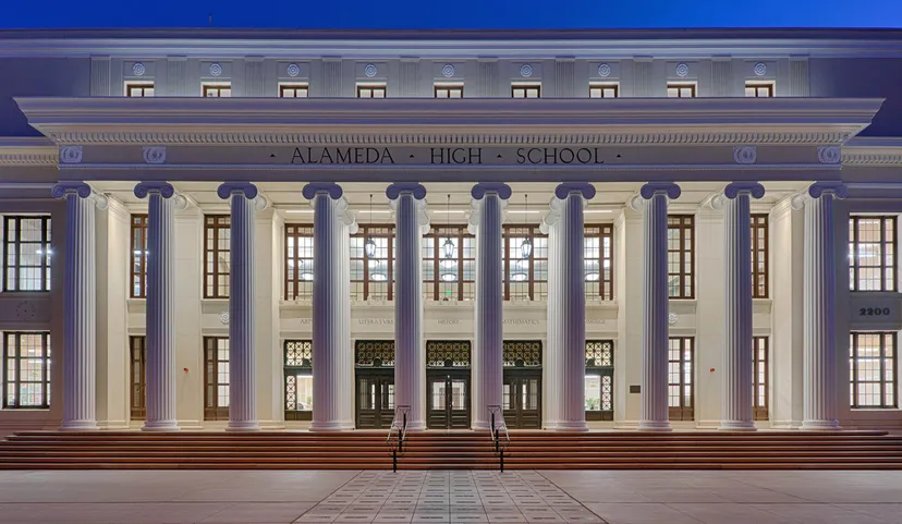 L'edificio principale neoclassico della Alameda High School si vede illuminato di notte.