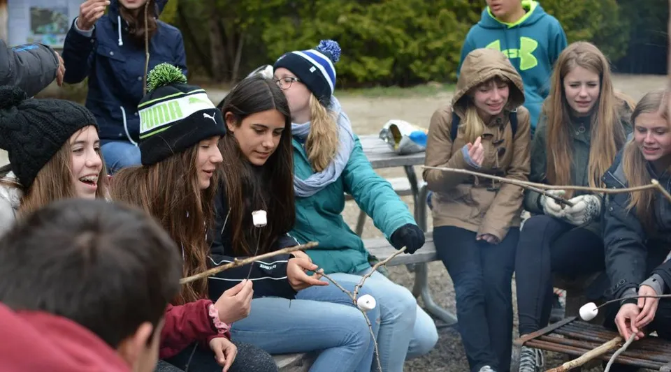 Un gruppo di studenti della Hamelin-Laie International School si riunisce all'aperto per un'attività sociale.
