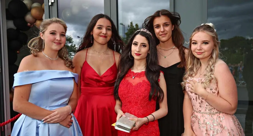 Un gruppo di cinque studentesse posa insieme all'aperto nel campus del St. Dominic’s College.