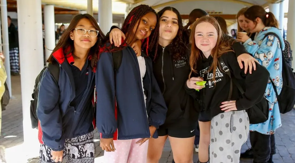 Un gruppo di studentesse si trova nel corridoio e posa per una foto nel campus della Leeming Senior High School.