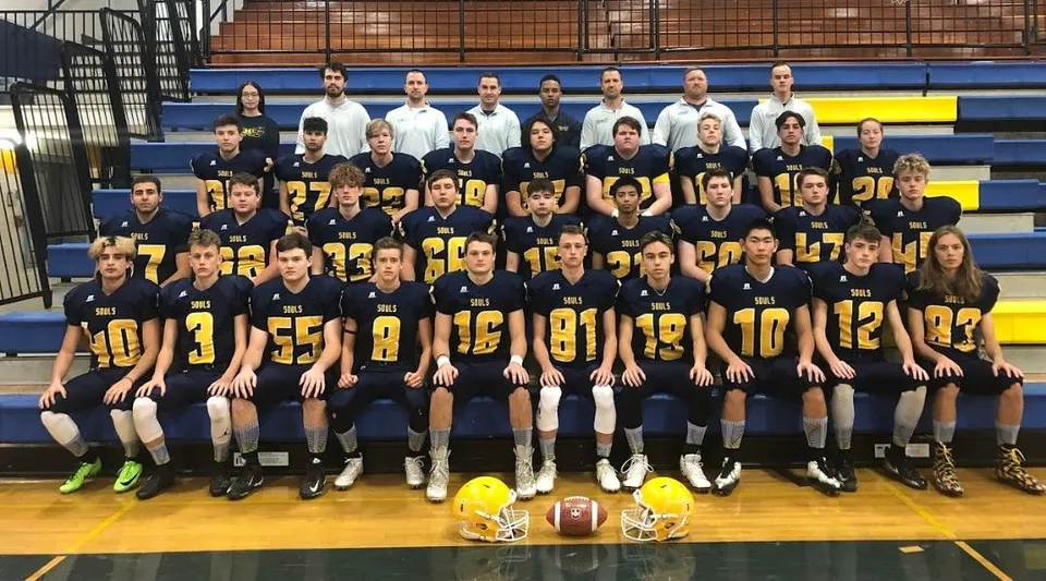 Gli studenti dell'Evan Hardy Collegiate si radunano in una palestra con attrezzatura sportiva.