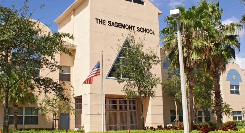 Il grande edificio della Sagemont School è circondato da palme e da una lussureggiante vegetazione tropicale.