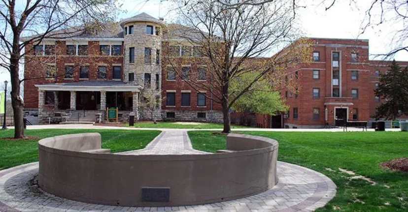 La fontana rotonda nel campus della Central Methodist University è circondata da edifici in mattoni e alberi.