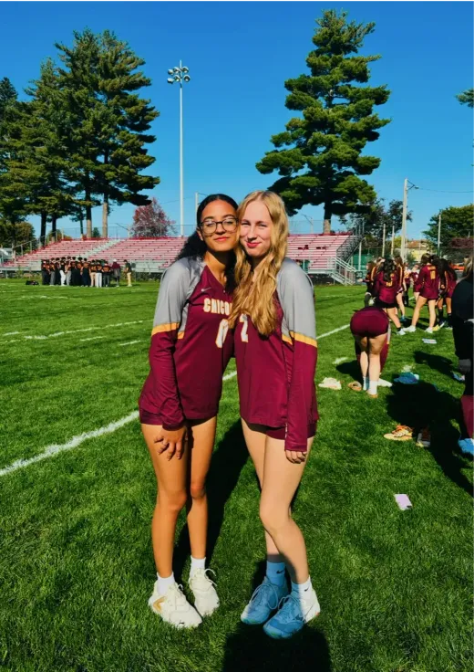 Due ragazze in maglia sportiva posano su un campo da gioco negli Stati Uniti