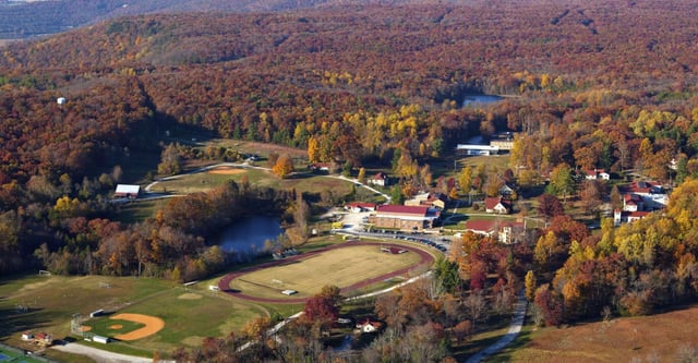 Paesaggio rurale autunnale con campo da baseball ed edifici nel campus della St. Andrew's-Sewanee School.