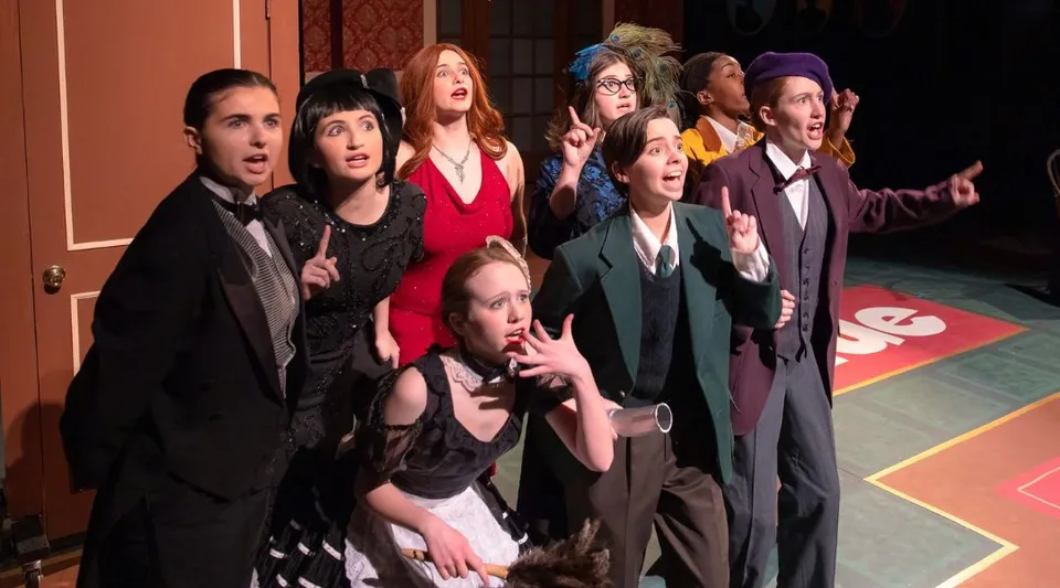 Un gruppo di studenti della Kent Place School si riunisce in un teatro con pavimento e pareti dai motivi colorati.