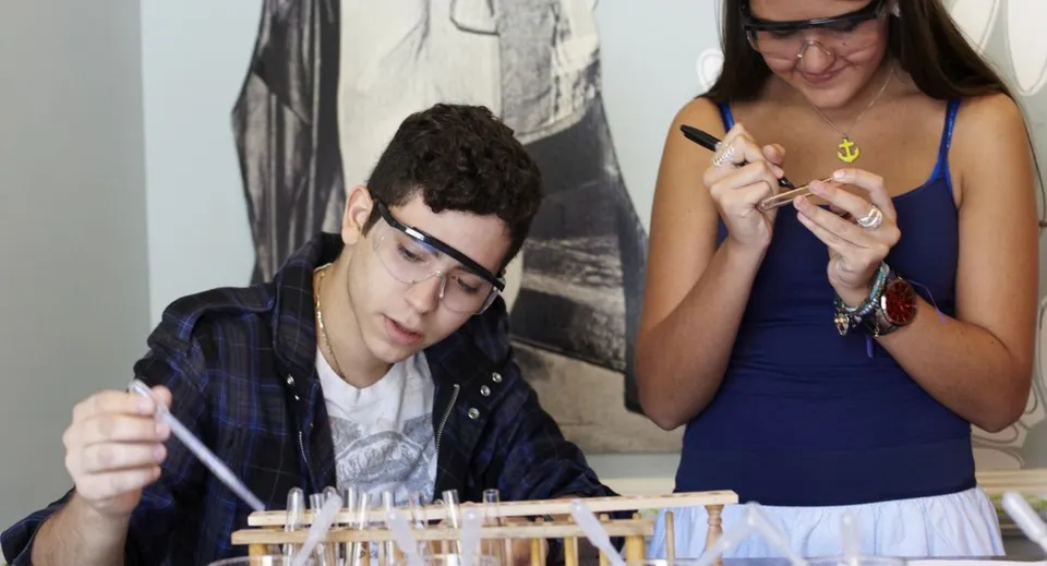 Studenti della The Beekman School lavorano concentrati a un compito seduti a un tavolo.