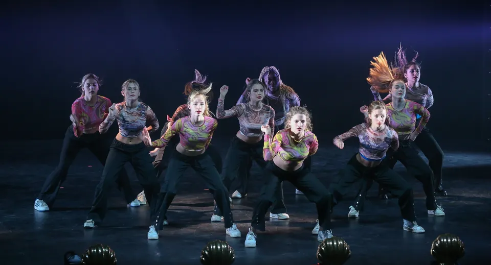 Un gruppo di ballerini e ballerine mette in scena uno spettacolo di danza variopinto sul palco della Bryanston School.