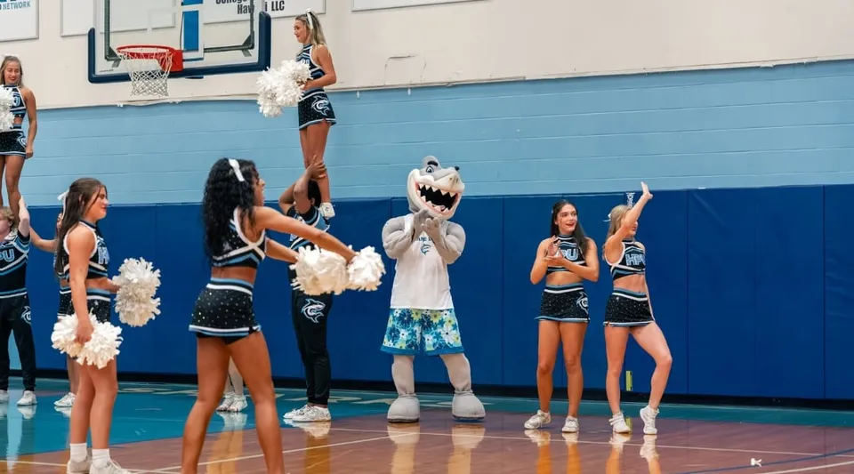 Cheerleader in uniformi colorate si esibiscono sul campo da basket della Hawai'i Pacific University.