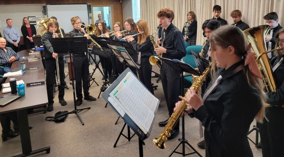 Un gruppo di musicisti prova nella sala spettacoli della Forestburg School con sassofoni e altri strumenti.