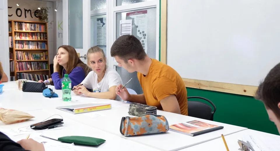 Tre studenti siedono a un tavolo nella biblioteca e studiano insieme nel campus della Keystone School.