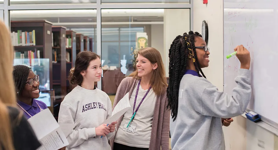 Un gruppo di studentesse e studenti della Ashley Hall School sta nel corridoio a conversare.