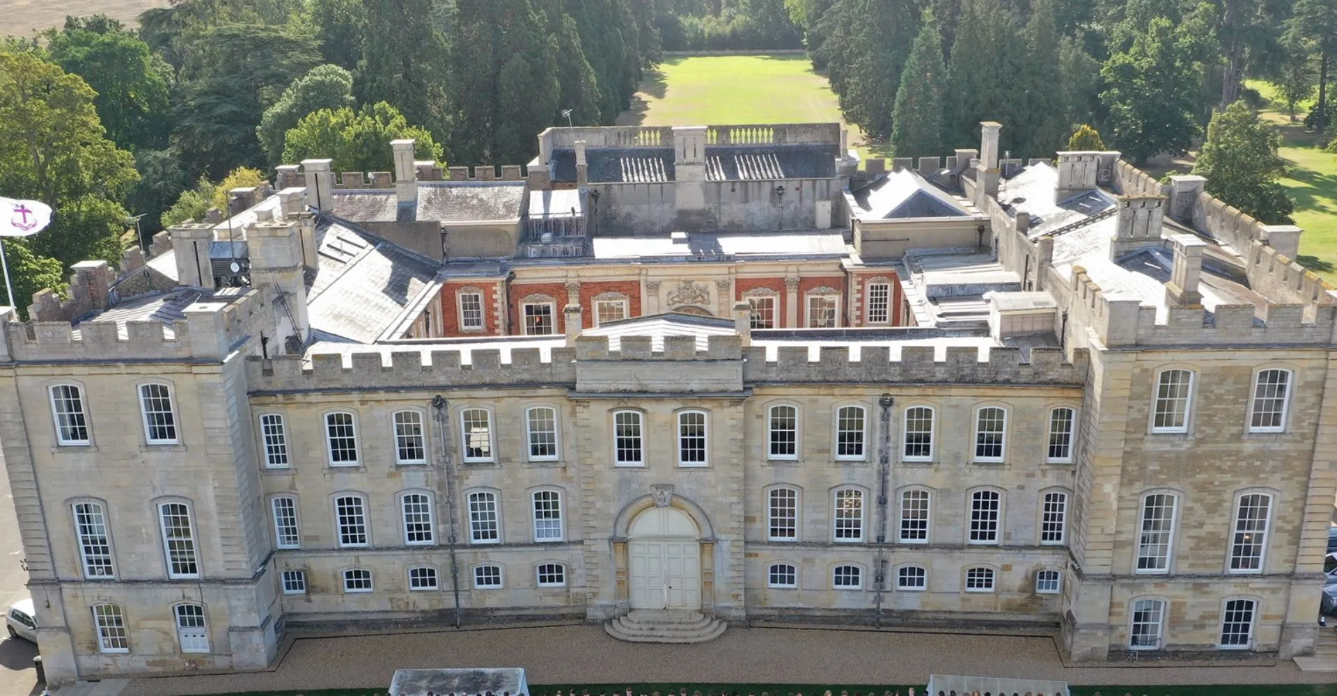 Vista aerea dello storico edificio principale della Kimbolton School con cortile interno e alberi.