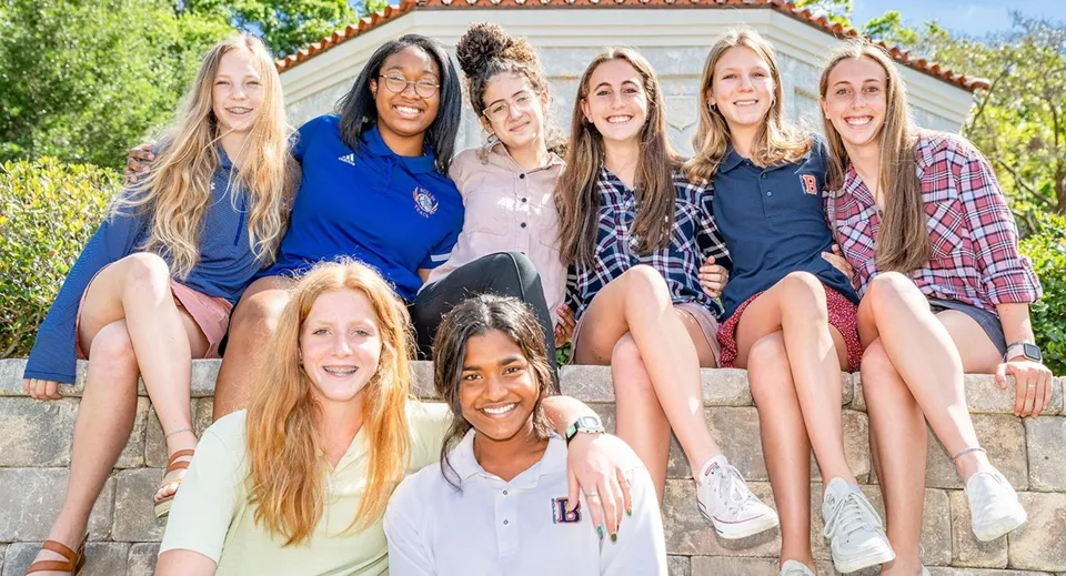 Un gruppo di studentesse è seduto sulle scale davanti a un edificio della The Bolles School.
