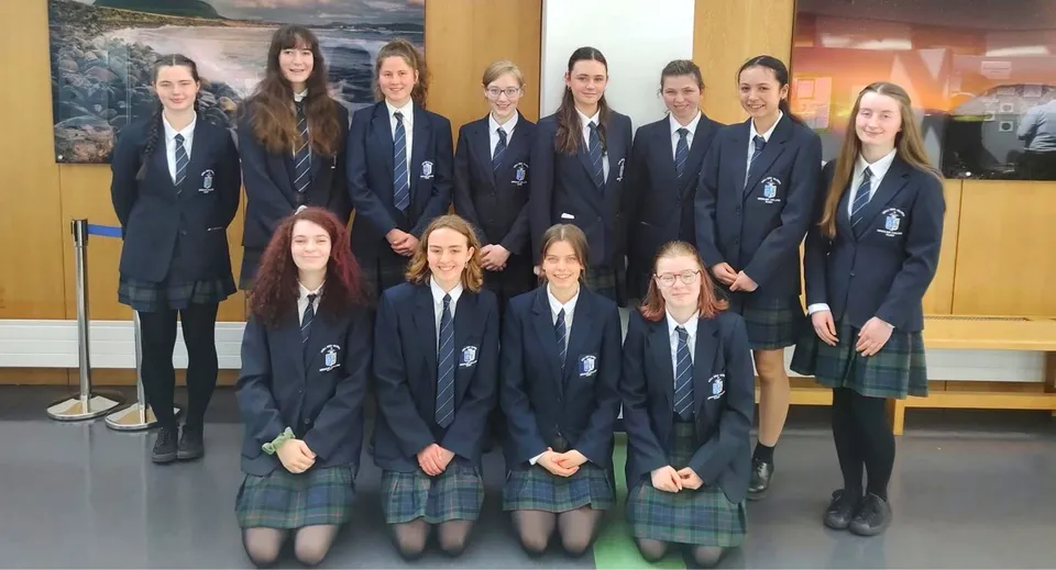 Un gruppo di studentesse e studenti dell'Ursuline College Sligo posa con un paesaggio sullo sfondo.