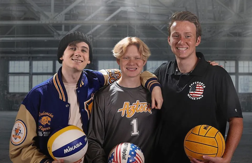 Tre studenti in maglie sportive si trovano insieme nella palestra della Esperanza High School.