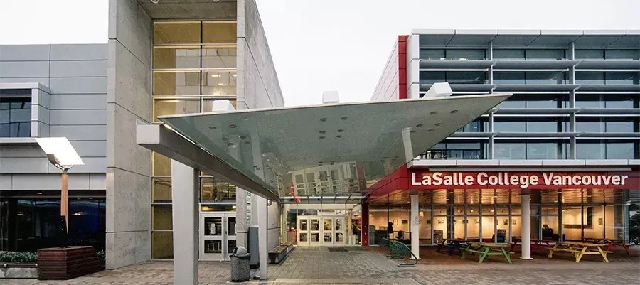 El moderno edificio de vidrio y acero con la entrada distintiva de LaSalle College Vancouver se ve en primer plano.