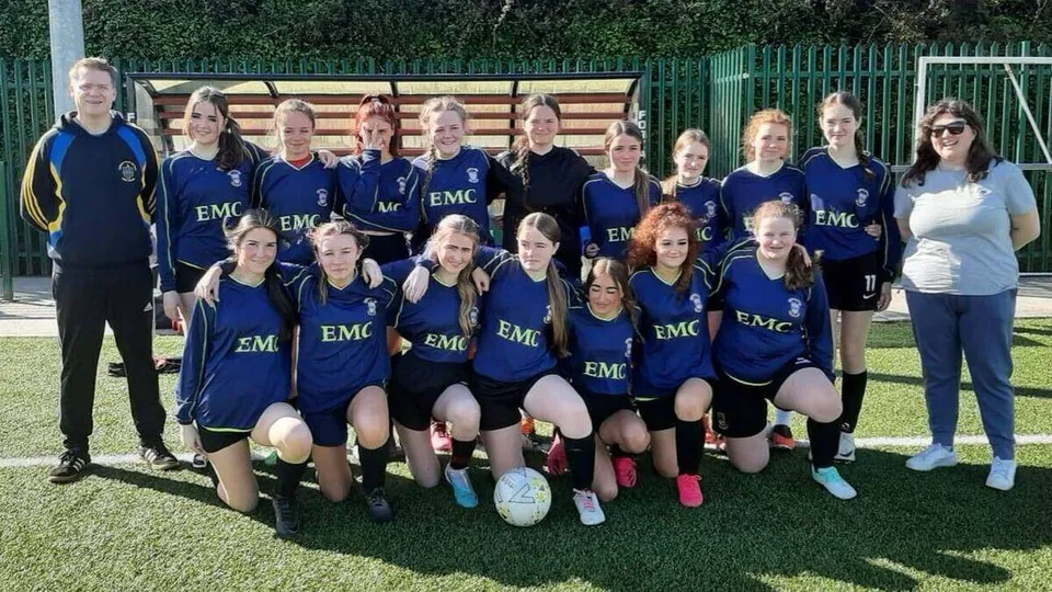 Un gruppo di calciatrici posa sul campo sportivo del Nagle Community College.