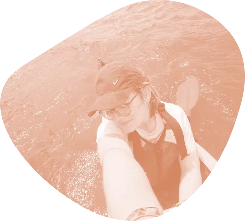 Studente in kayak con cappellino si fa un selfie durante un'escursione sull'acqua