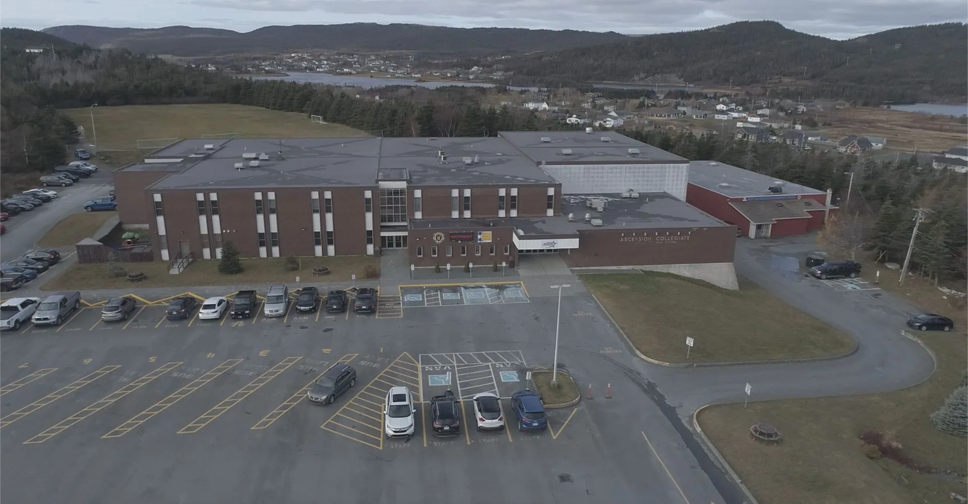 L'ampio edificio commerciale con parcheggio davanti a un paesaggio montano nel campus della Ascension Collegiate.