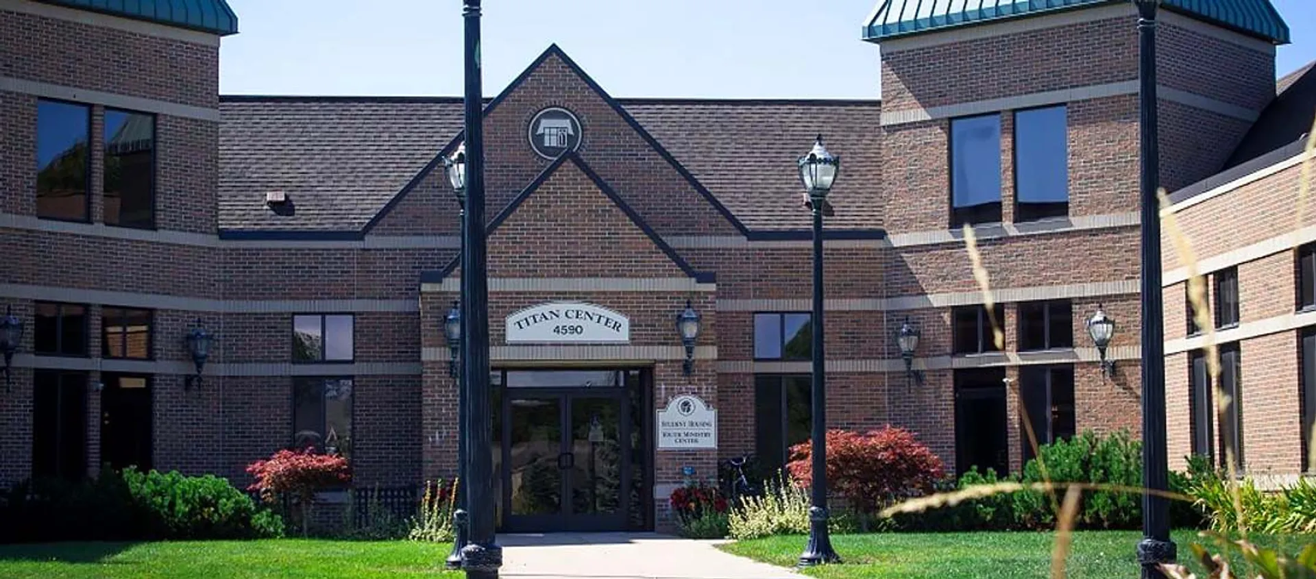 Edificio con facciata in mattoni e insegna d'ingresso Titan Center nel campus della Michigan Lutheran High School.