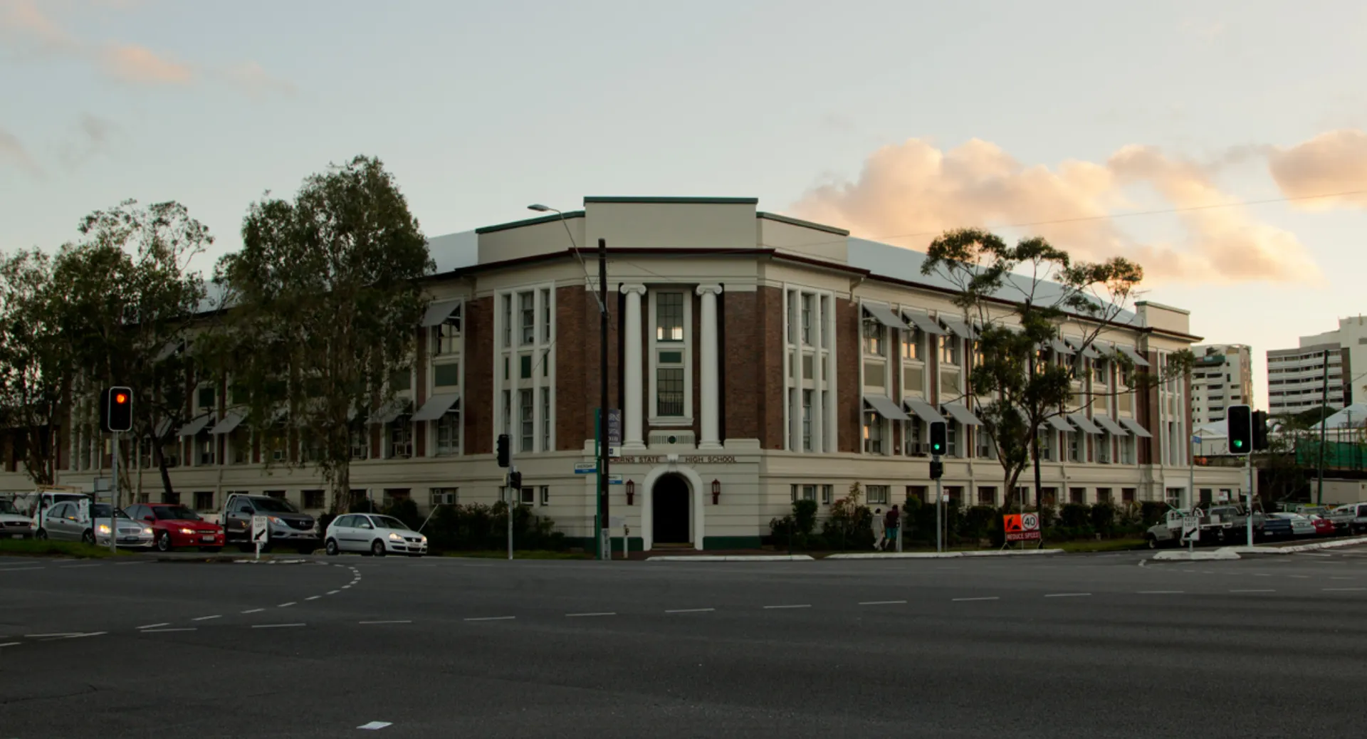 L'imponente edificio principale della Cairns State High School è circondato da palme e aree verdi.
