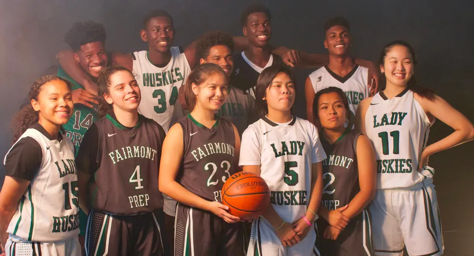 Un gruppo di giovani giocatrici e giocatori di basket posa insieme con le divise della squadra per la foto ufficiale della Fairmont Prep Academy.